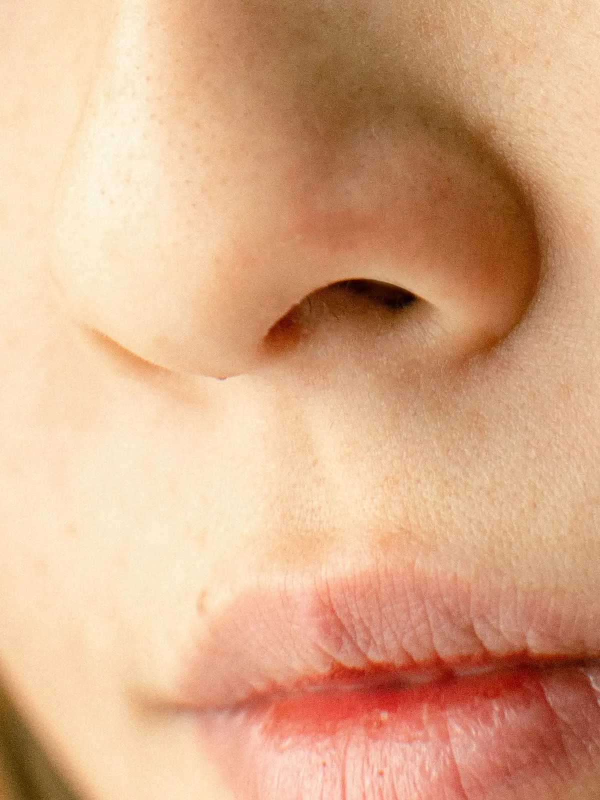 Close view of a woman’s nose and lips